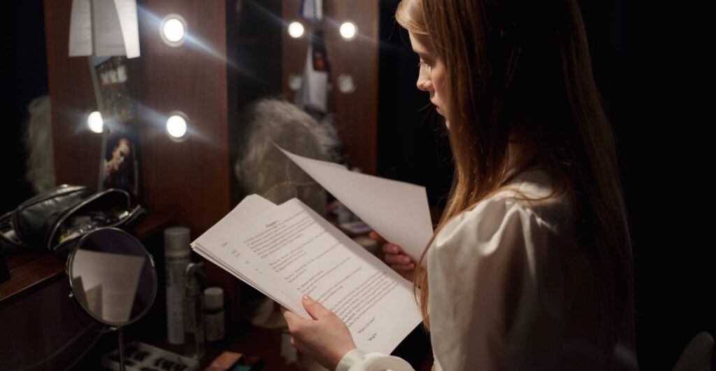 actor going through her script backstage